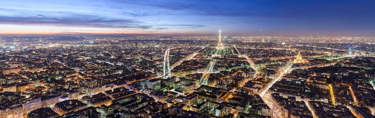 Paris skyline at dusk seen from the Montparnasse tower, with the Eiffel Tower lit up